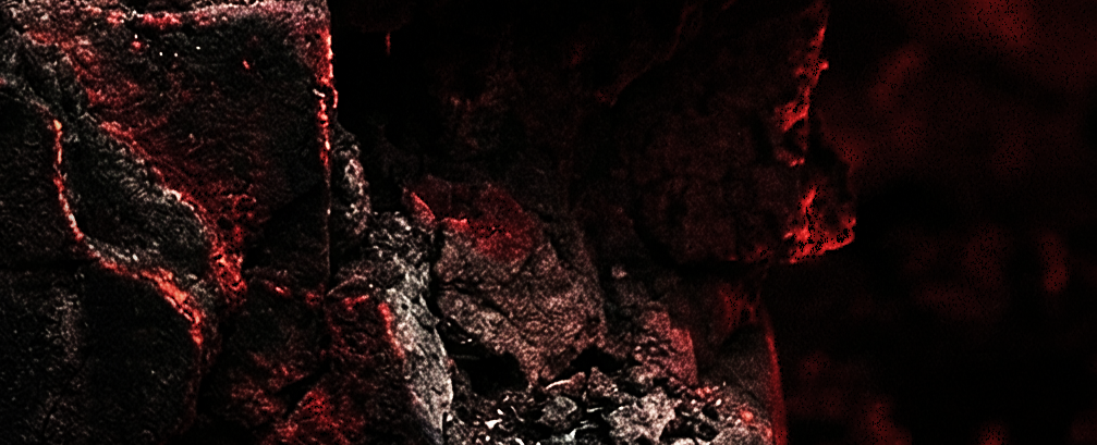 תקריב של סלעים כהים ומחוספסים עם אור אדום עז הבוקע מבין הסדקים, במראה המזכיר לבה רותחת או גחלים.